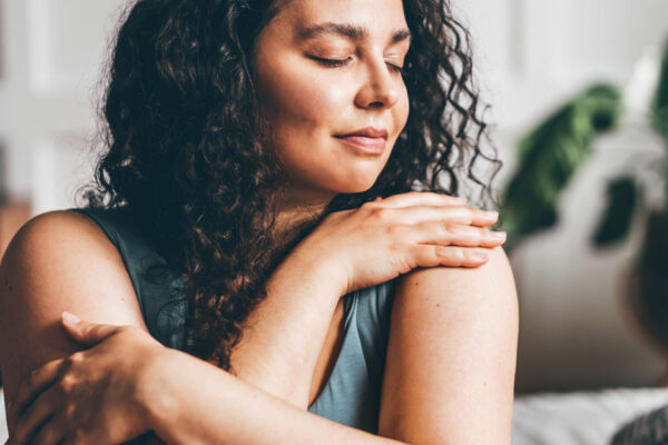 Young Curvy Woman Hugs Herself