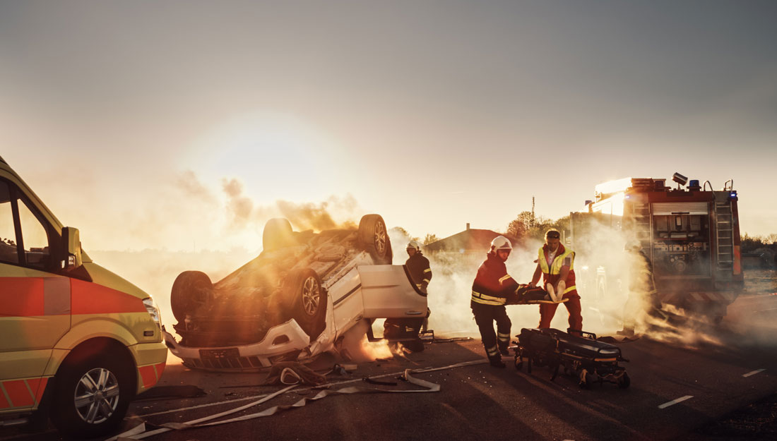 Paramedics and Firefighters Rescue person from a Vehicle crashed upside down on a road