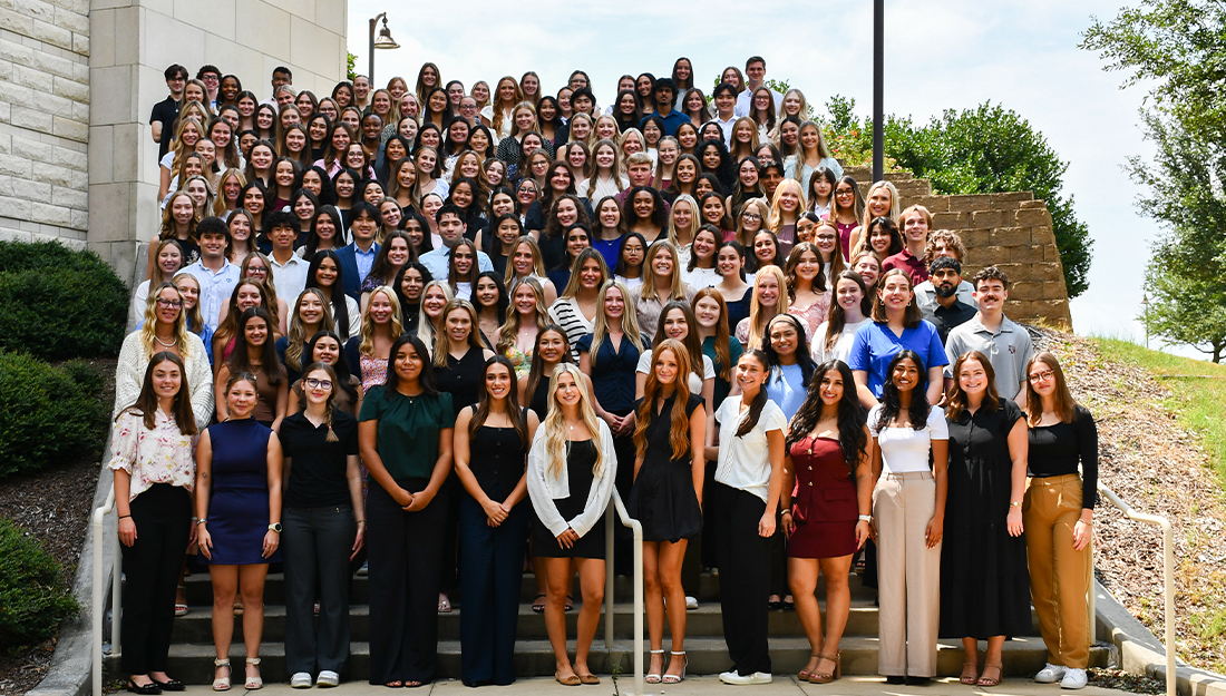 Group photo of the largest incoming cohort for Fall 2025 at Texas A&M University’s College of Nursing, Bryan-College Station campus. Dozens of students stand together on outdoor steps, smiling at the camera.